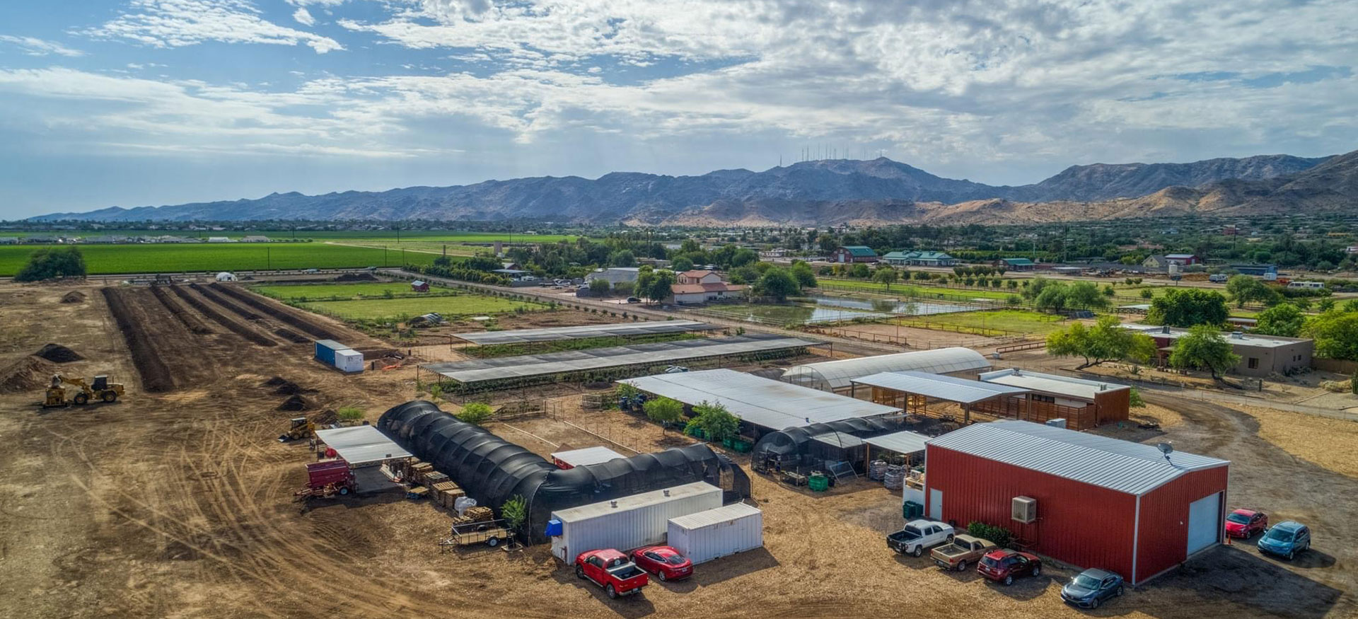 aerial view looking south east over the Arizona Worm Farm in South East Phoenix with South Mountain Park in the background on a cloudy but sunny day